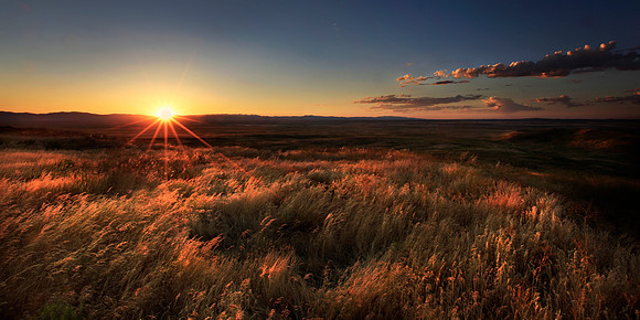 First rays of the sun touch the top of Initial Point Butte, Id.